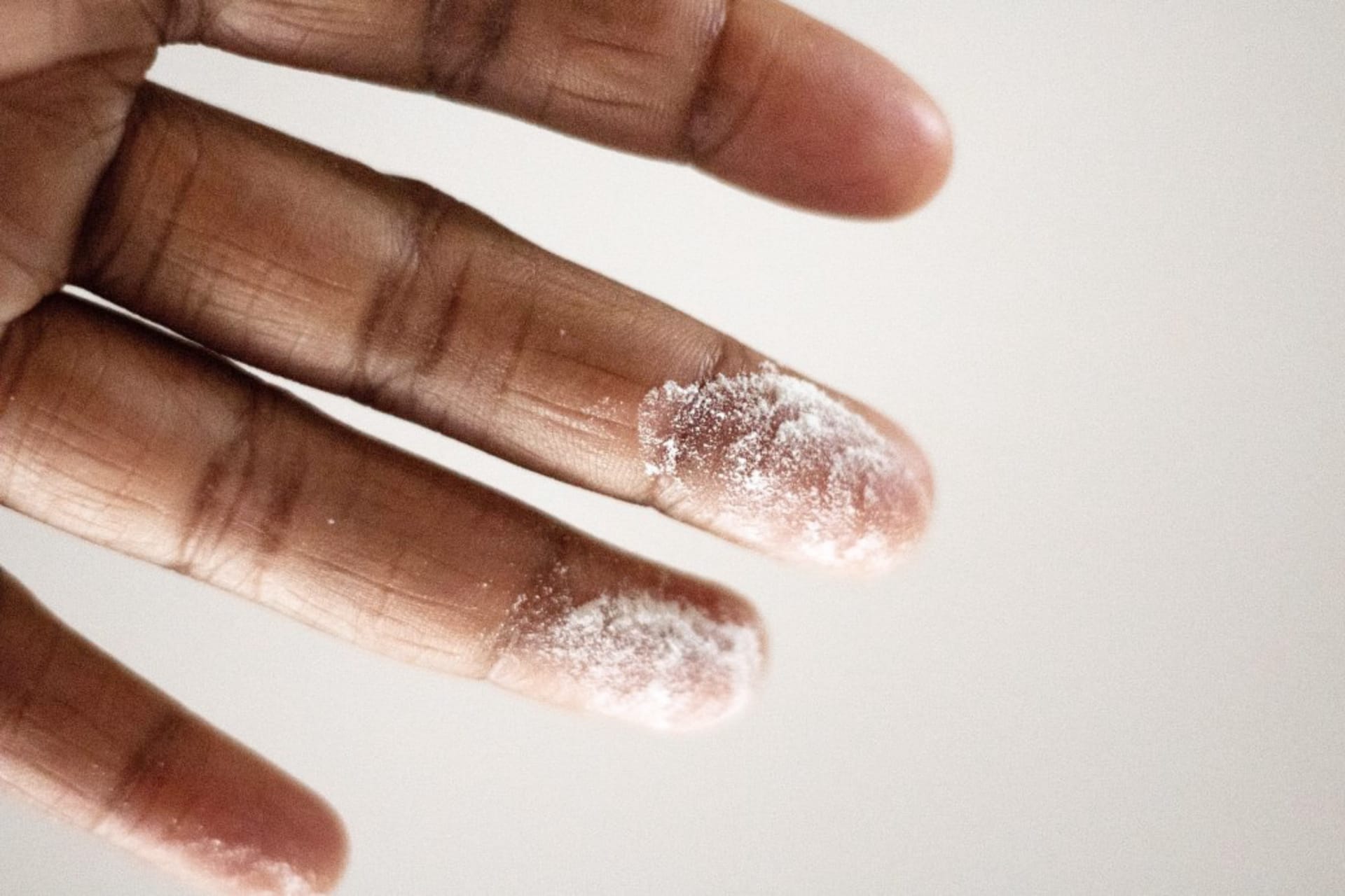 powder on fingers